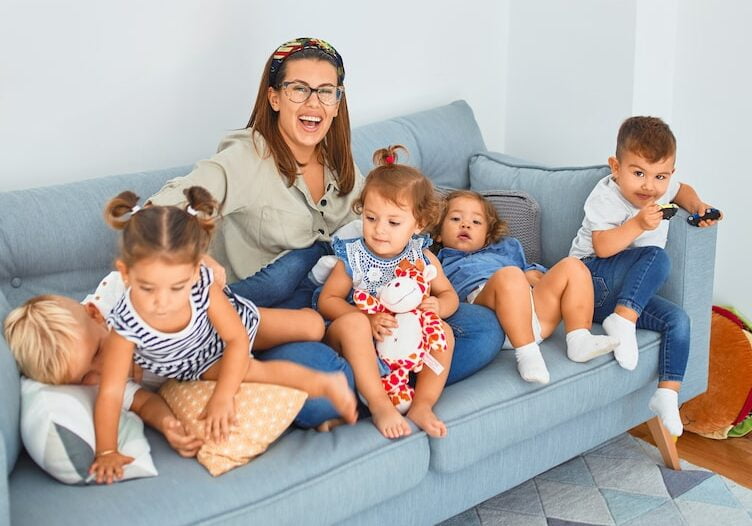 3 women sitting on gray couch